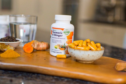 Turmeric & Ginger - Bottle And Capsules In Focus